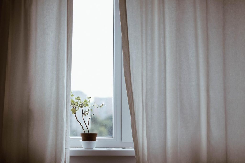 Gevoerde gordijnen in woonkamer die zorgen voor warmte, privacy en geluiddemping voor beter wooncomfort